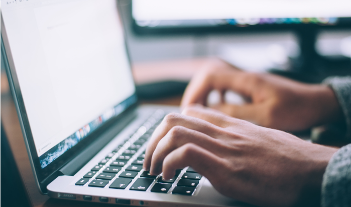 Manos tecleando en un ordenador portátil